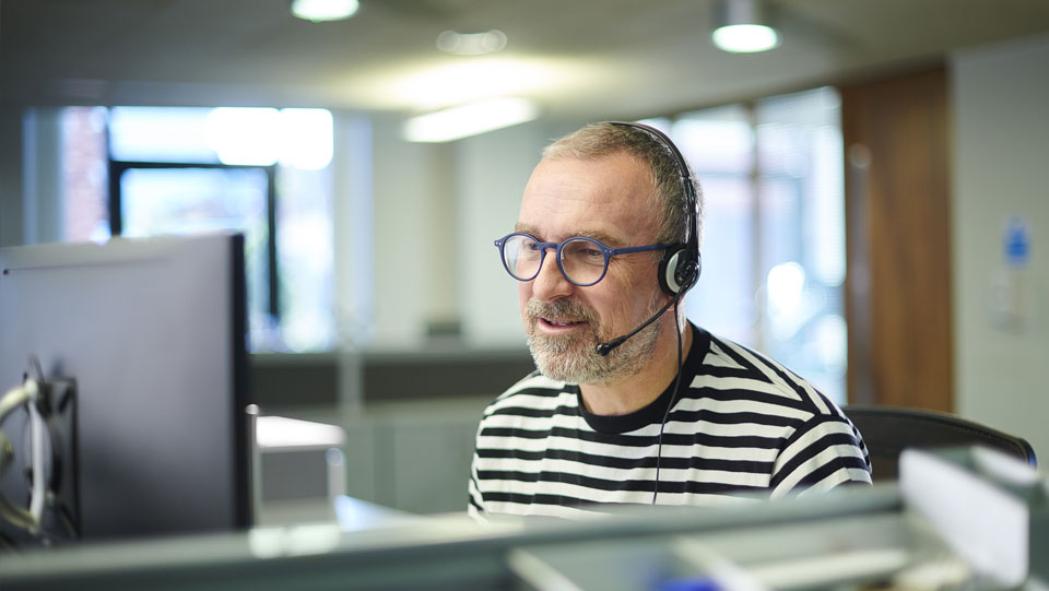 A helpdesk colleague in our office taking a call